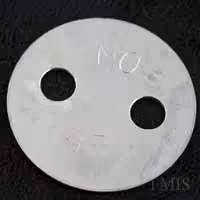Stainless Steel 2-hole lacing washer on dark background.